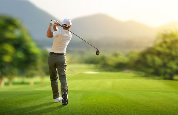 Man golfing in the mountains